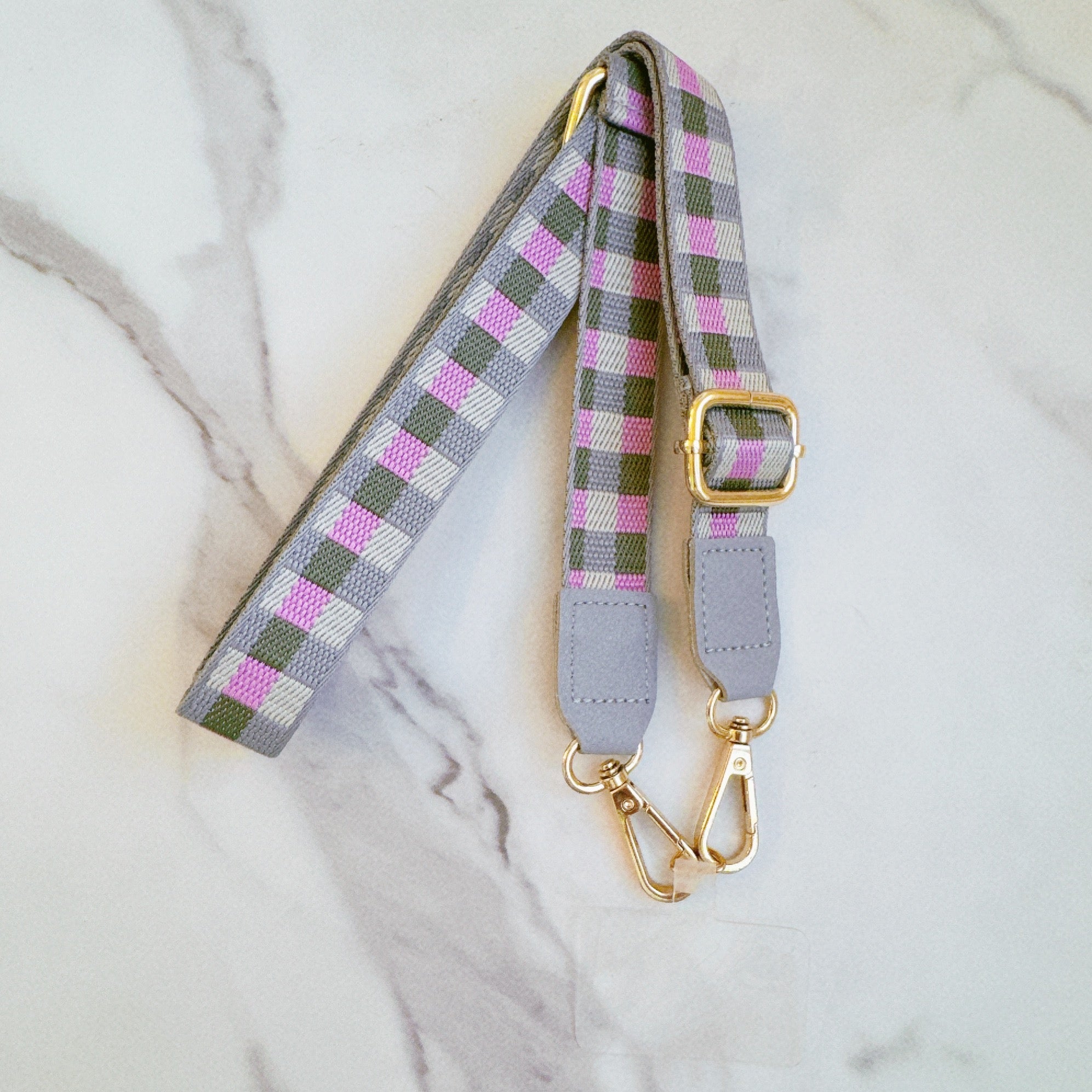 Plaid bag phone crossbody with gold hardware on a marble surface